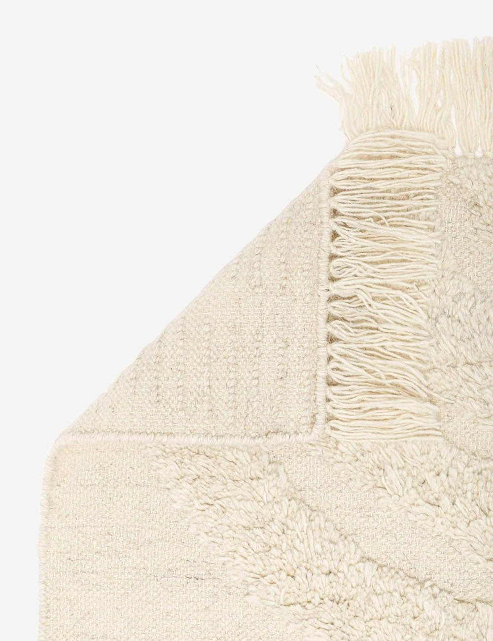 The corner of the Arches natural Rug folded over itself