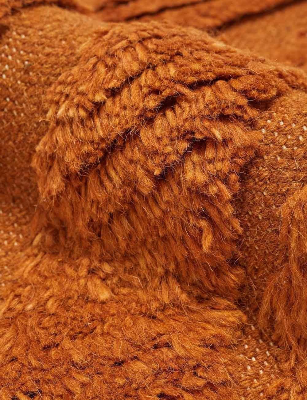 The 100% wool construction of the Arches rust orange Rug