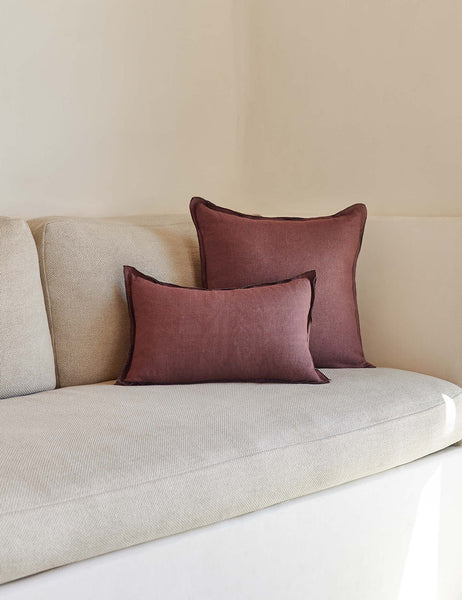 #color::aubergine #style::lumbar #fill type::with-feather-down-insert #fill type::pillow-cover-only | The arlo Aubergine burgundy flax linen pillow in its lumber and square sizes sit together on a natural linen sofa