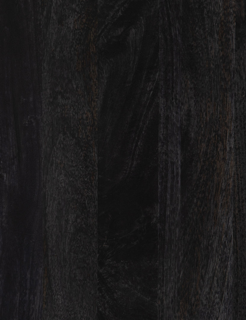 #color::black-and-natural | Close-up of the black mango wood on the Hannah black mango wood sideboard with cane doors and an iron base.