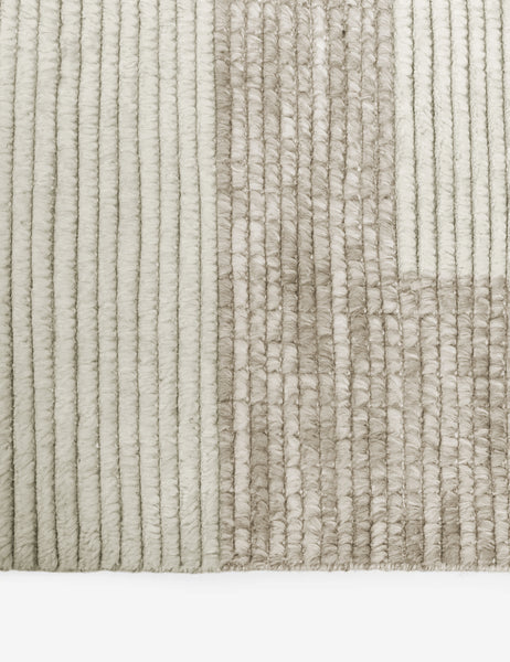 #size::2-6--x-8- #size::6--x-9- #size::8--x-10- #size::9--x-12- #size::10--x-14- #size::12--x-15- | Close-up of the two-toned ribbed fabric on the Nomad neutral-toned geometric floor rug by Élan Byrd