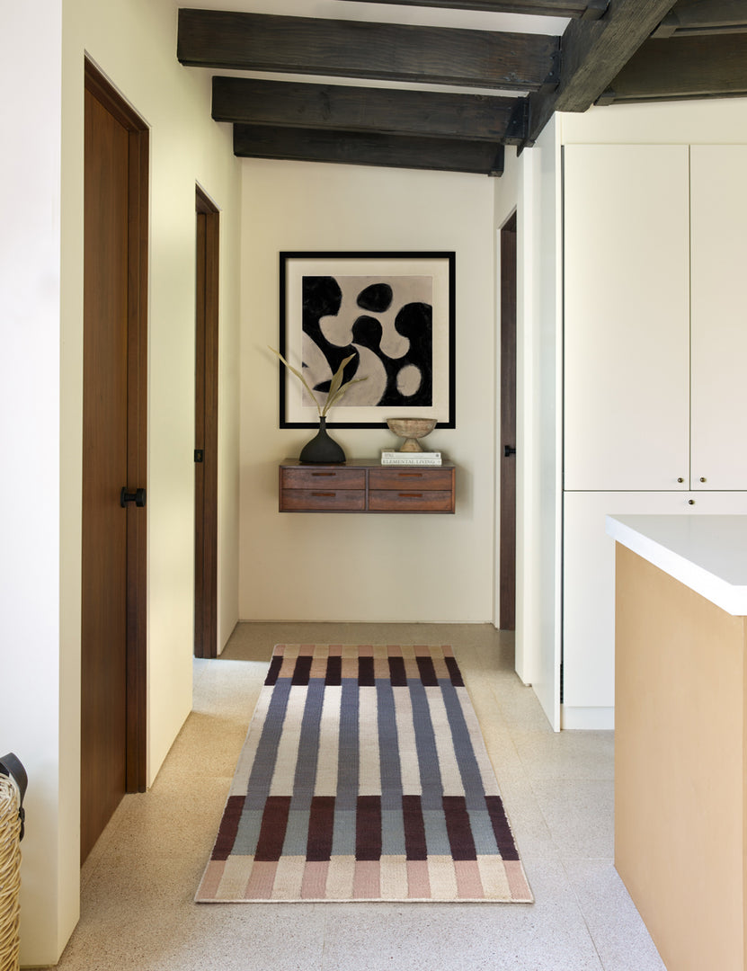#size::2-6--x-8- | The otti rug in its runner size lays in a hallway that has beamed ceilings, a wooden wall shelf, and an abstract wall art