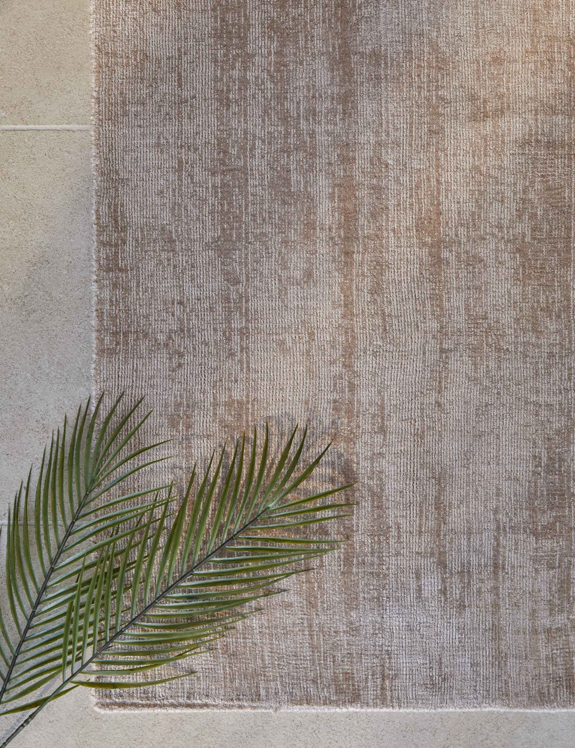 Bird's-eye view of the corner of the dusk dylan rug with a plant sitting atop it