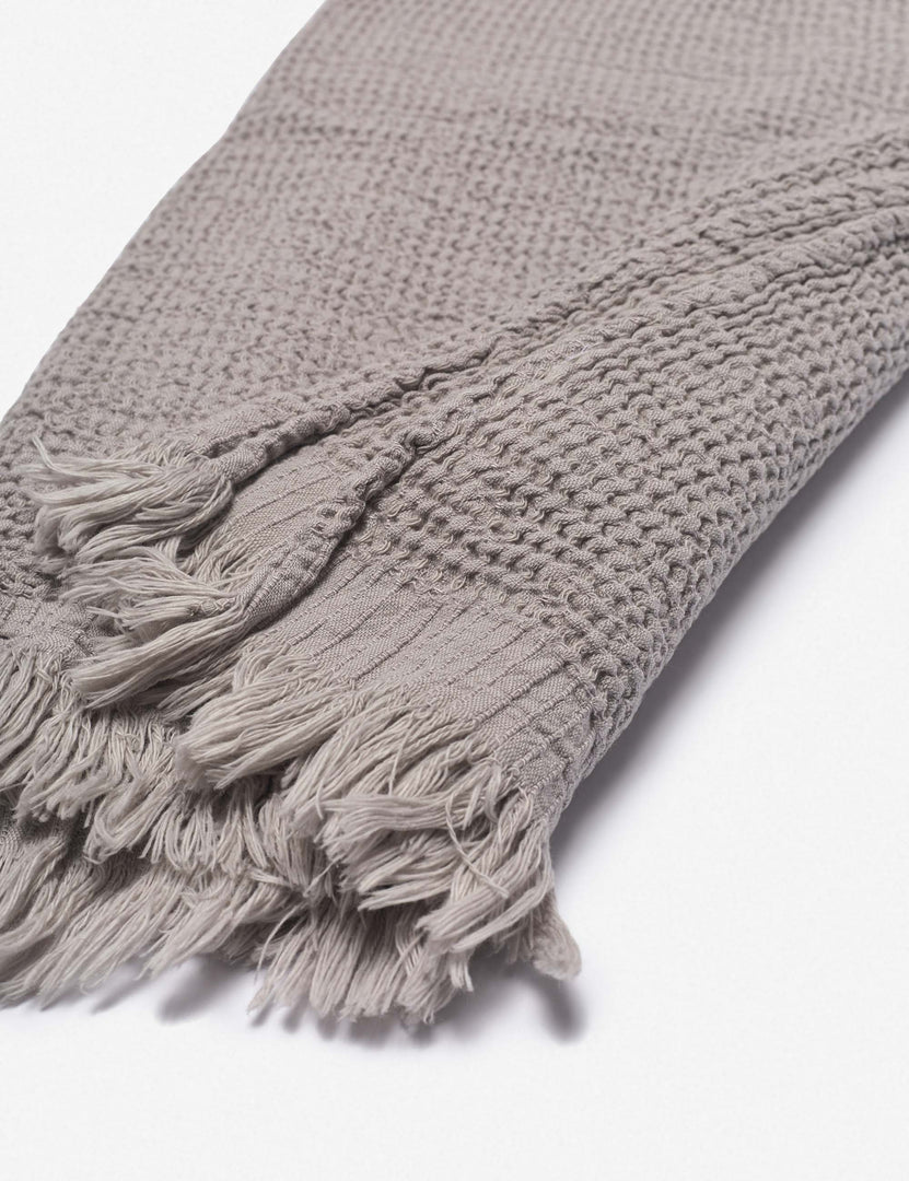 #color::stone | Close up of the tasseled ends on the Sherra stone grey Waffle Towel by House No. 23