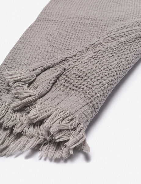 #color::stone | Close up of the tasseled ends on the Sherra stone grey Waffle Towel by House No. 23