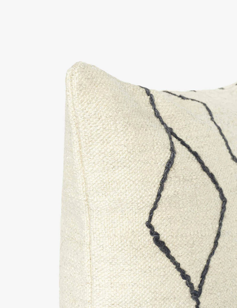 Close-up of the corner of the Moroccan black and natural beni ourain inspired square flat weave pillow by Sarah Sherman Samuel