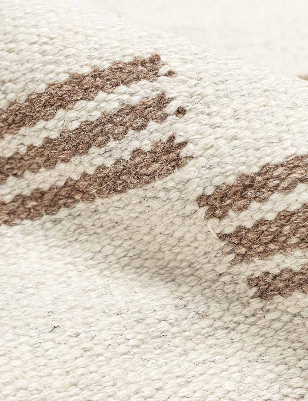 Detailed shot of the flatwoven texture on the Stripe break rug by Sarah Sherman Samuel