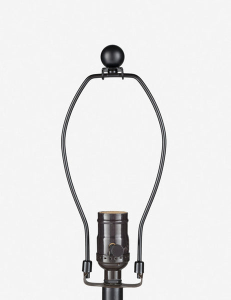 #color::tan | Close-up of the bronze light fixture on the Vivienne tan ceramic table lamp with spherical base